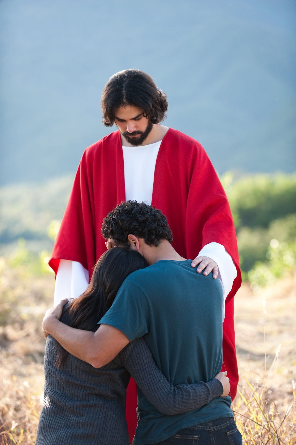 Sad couple with Jesus by their side